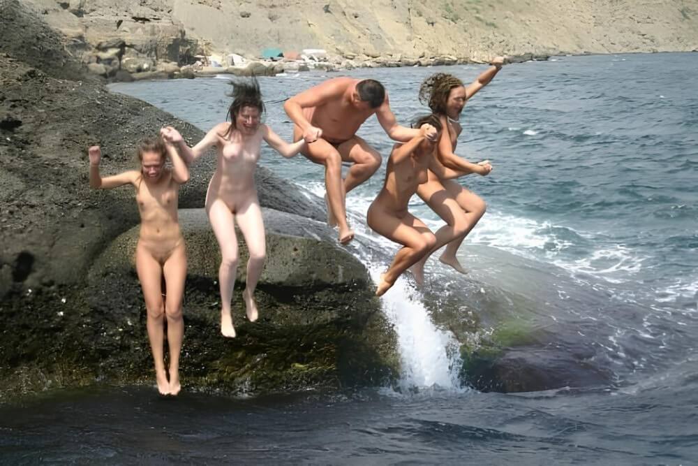 Mens and girls nudists on a beach - Nudism and naturism as a philosophy of life based on respect and acceptance